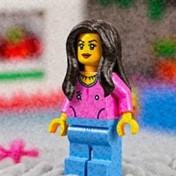 Lego de mujer con cabello largo, pantalon azul y playera rosa mexicano