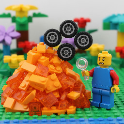 pile of orange pieces and 4 wheels stacked at the left, confused minifigure at the right