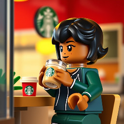 A brown coloured girl with black small  hair drinking latte at starbucks in jogging cloth